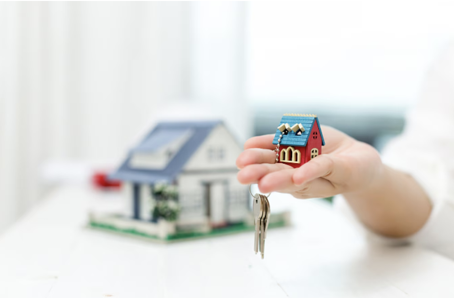 Real Estate Agent Holding a Miniature House