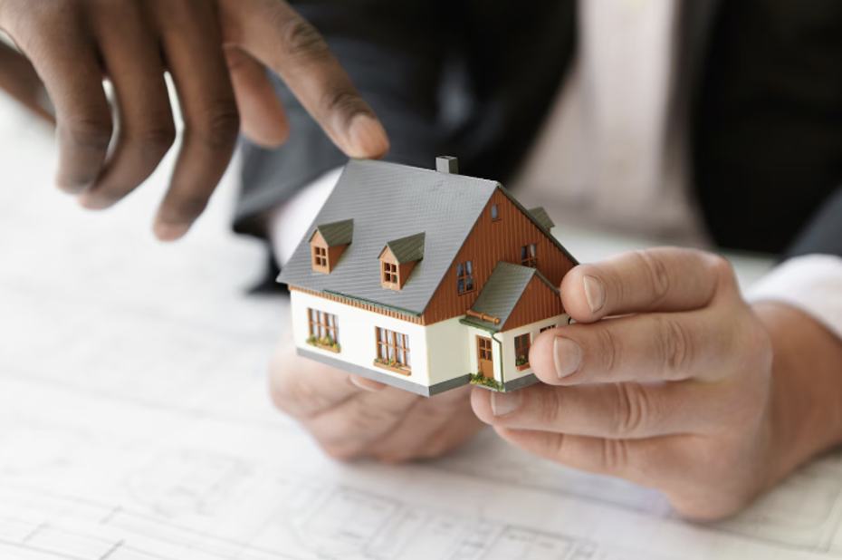 Realtor Holding a Miniature House 