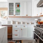a kitchen with white cabinetry