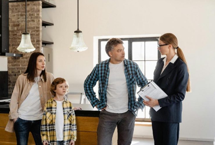 A real estate agent speaking to a family