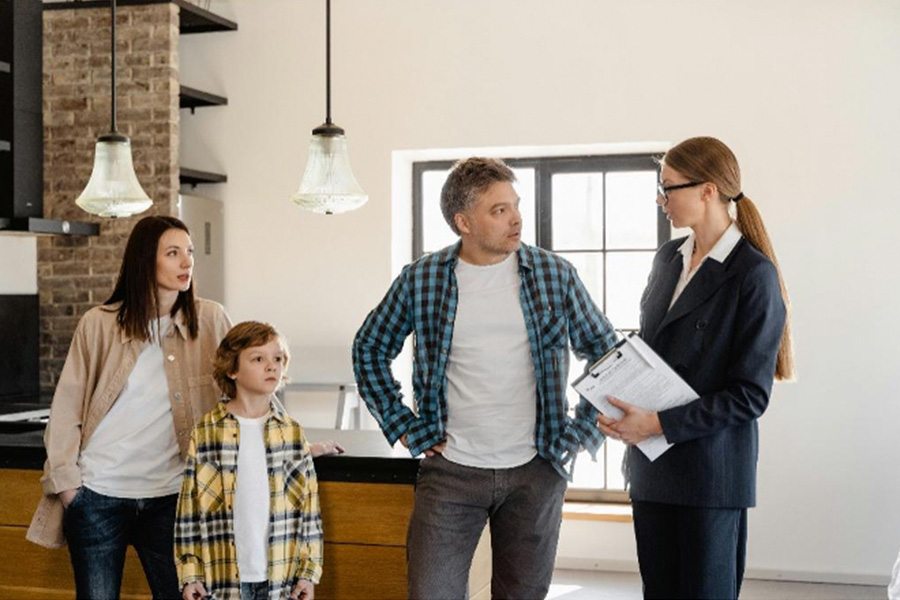 A real estate agent speaking to a family